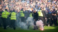 ‘Shameful’ pitch invasion by Celtic and Rangers fans condemned by police