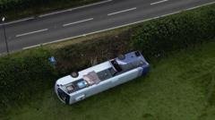 Nineteen injured after bus overturns in crash near roundabout